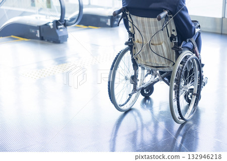 A man in a suit sitting in a wheelchair A man in a suit sitting in a wheelchair 132946218