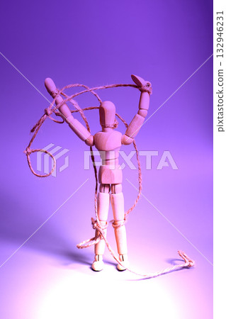 Wooden puppet with strings. Concept of emotional manipulation,dictatorship and control 132946231