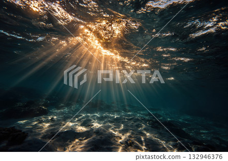 Rays of light shining under dark water during sunrise. 132946376