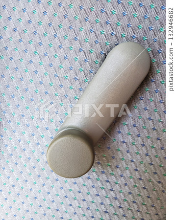 Close-up of manual car window crank handle on patterned grey-blue upholstery inside 1990s sedan, symbolizing retro automotive engineering and nostalgic details from pre-digital era Close-up of manual car window crank handle on patterned grey-blue upholstery inside 1990s sedan, symbolizing retro automotive engineering and nostalgic details from pre-digital era 132946682