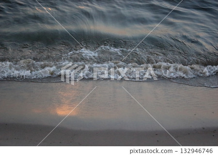 Sea wave washing sandy beach at sunset Sea wave washing sandy beach at sunset 132946746