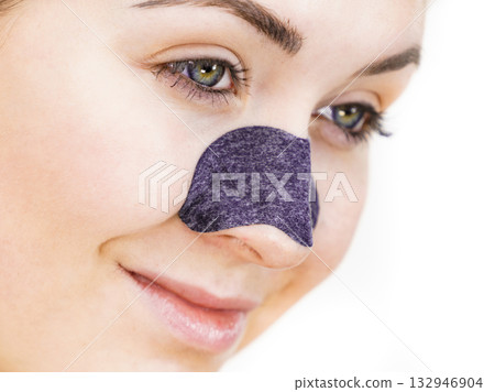 Woman applying pore strips on nose 132946904