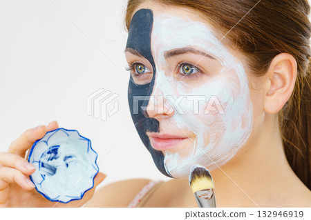 Girl black mask on half face apply white mud 132946919