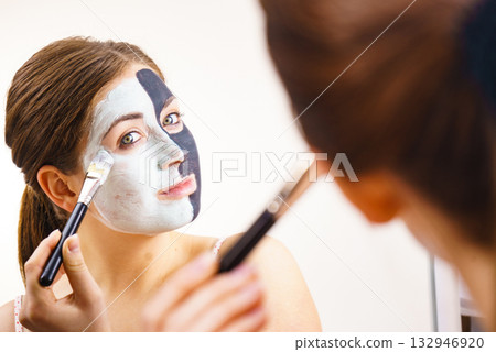 Girl black and green mud mask on face Girl black and green mud mask on face 132946920