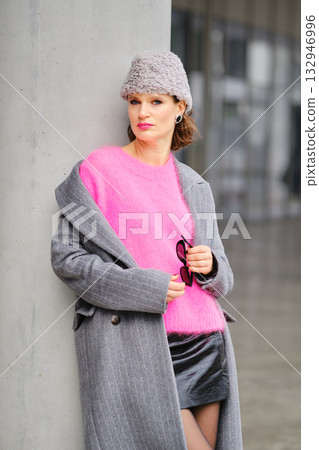 Stylish woman in urban street fashion with colorful outfit and sunglasses in modern city setting Stylish woman in urban street fashion with colorful outfit and sunglasses in modern city setting 132946996