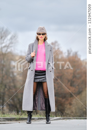 Urban street style with bold colors and elegant layering in a city setting 132947009