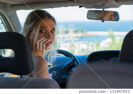 Young driver woman behind steering wheel 132947053