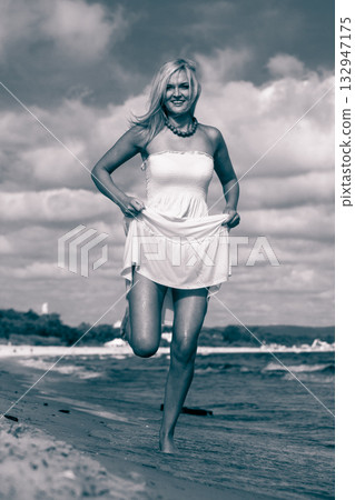 Female tourist walking on beach. 132947175