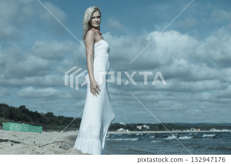 Young lady resting on beach. 132947176
