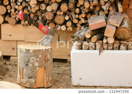 Large and small firewood stored for the wood stove Large and small firewood stored for the wood stove 132947290