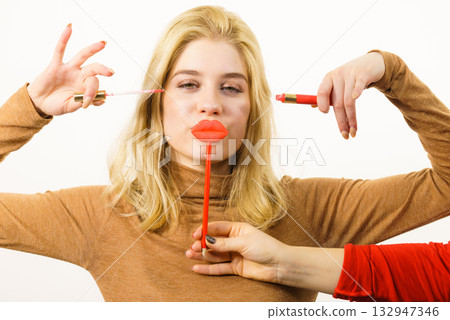 Woman applying lipstick or lip gloss Woman applying lipstick or lip gloss 132947346