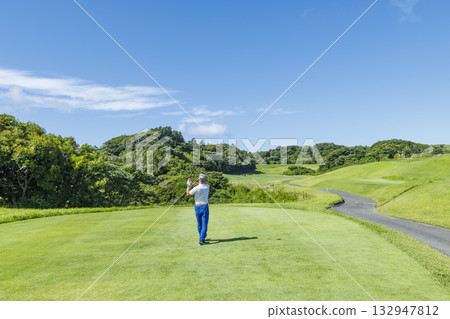 People playing at a beautiful green golf course 132947812