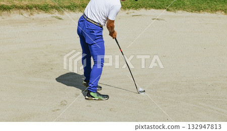 Golfer taking a shot in a bunker Golfer taking a shot in a bunker 132947813