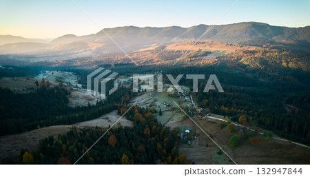 Aerial drone view of alpine countryside with mountain hills, coniferous forest, slopes and houses Aerial drone view of alpine countryside with mountain hills, coniferous forest, slopes and houses 132947844