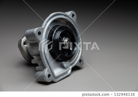 New cooling pump for internal combustion engine of a passenger car on a gray background New cooling pump for internal combustion engine of a passenger car on a gray background 132948138