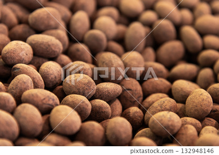 Close-up of brown dragee, chocolate covered nuts, sweet candy background. 132948146