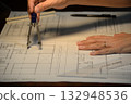 A scene of using a compass for architectural design drawings at home at night 132948536