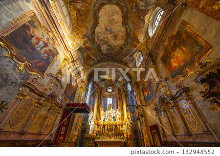 Baroque church interior with ornate altar in Nitra 132948552