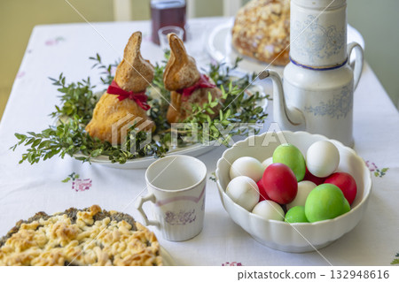 Easter holiday table setting with bunny bread and colored eggs 132948616