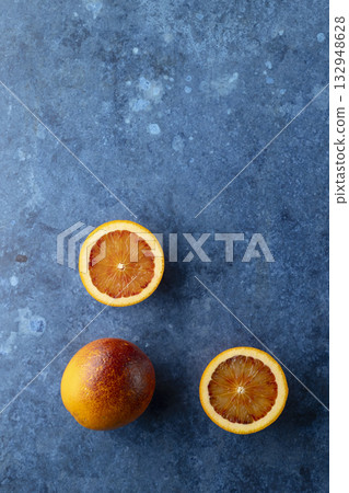 Fresh blood oranges offering healthy vitamin C on blue background 132948628