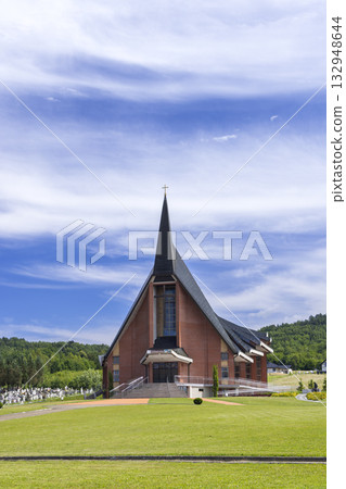 Parish church building standing against blue sky in Jasienica Rosielna, Poland 132948644