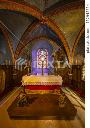 Ornate chapel interior showcasing stained glass and altar in Commarin Ornate chapel interior showcasing stained glass and altar in Commarin 132948834