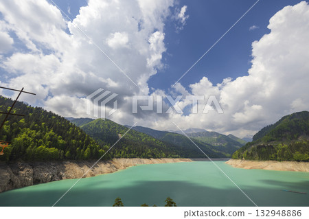 Sauris lake showing turquoise water and alpine mountains 132948886