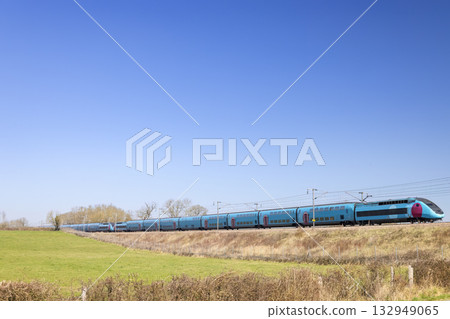 High speed passenger train traveling through the French countryside High speed passenger train traveling through the French countryside 132949065