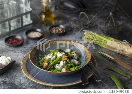 Healthy grilled halloumi salad with asparagus and peas Healthy grilled halloumi salad with asparagus and peas 132949088