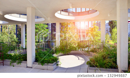 Modern luxury office building.The structure features a glass and concrete walls, showcasing contemporary architecture. The green surroundings of office buildings. Trees and shrubs in the city. Modern luxury office building.The structure features a glass and concrete walls, showcasing contemporary architecture. The green surroundings of office buildings. Trees and shrubs in the city. 132949887