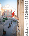 Close-up of female legs with red shoes of high heels. The woman is raising her feet through the window 132949942