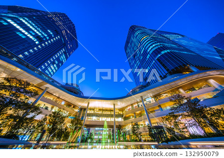 New Tokyo cityscape in Japan. View of Takanawa Gateway City in front of Takanawa Gateway Station. Illuminated fountain. New Tokyo cityscape in Japan. View of Takanawa Gateway City in front of Takanawa Gateway Station. Illuminated fountain. 132950079