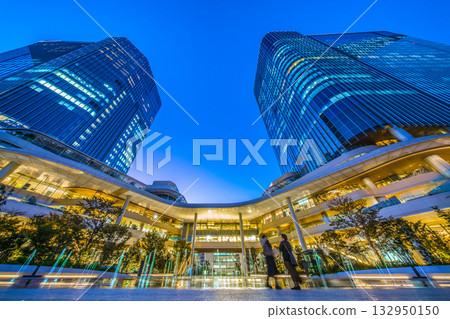 New Tokyo cityscape in Japan. View of Takanawa Gateway City in front of Takanawa Gateway Station. Illuminated fountain. New Tokyo cityscape in Japan. View of Takanawa Gateway City in front of Takanawa Gateway Station. Illuminated fountain. 132950150