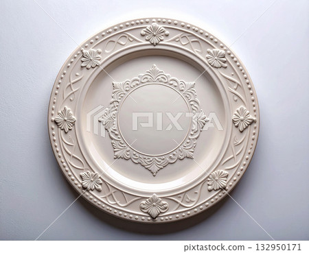 Vintage elegance. Ceramic plate with a classic white design and floral border on a white background. Porcelain kitchenware. Close-up. Top view. Vintage elegance. Ceramic plate with a classic white design and floral border on a white background. Porcelain kitchenware. Close-up. Top view. 132950171