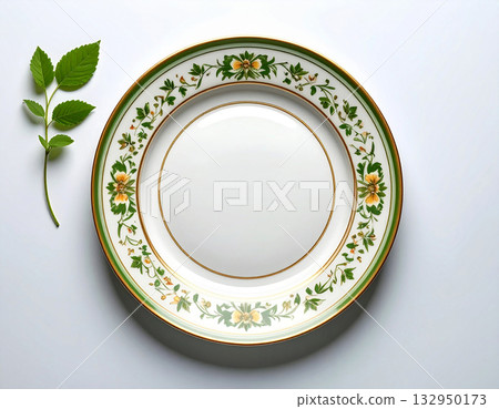 Classic elegance. Ceramic plate with a green and gold pattern on a white background. Porcelain kitchenware. Close-up. Top view. Classic elegance. Ceramic plate with a green and gold pattern on a white background. Porcelain kitchenware. Close-up. Top view. 132950173