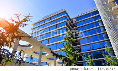 Exterior of modern high-rise buildings in a business district. Tall office buildings. Glass-fronted skyscrapers. Modern business district. Exterior of modern high-rise buildings in a business district. Tall office buildings. Glass-fronted skyscrapers. Modern business district. 132950237
