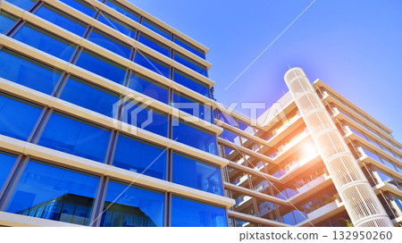 Exterior of modern high-rise buildings in a business district. Tall office buildings. Glass-fronted skyscrapers. Modern business district. Exterior of modern high-rise buildings in a business district. Tall office buildings. Glass-fronted skyscrapers. Modern business district. 132950260