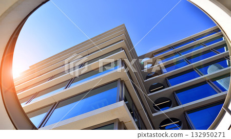 Exterior of modern high-rise buildings in a business district. Tall office buildings. Glass-fronted skyscrapers. Modern business district. Exterior of modern high-rise buildings in a business district. Tall office buildings. Glass-fronted skyscrapers. Modern business district. 132950271