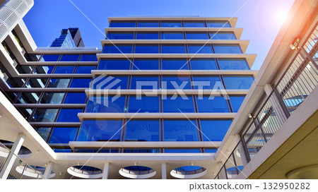 Exterior of modern high-rise buildings in a business district. Tall office buildings. Glass-fronted skyscrapers. Modern business district. Exterior of modern high-rise buildings in a business district. Tall office buildings. Glass-fronted skyscrapers. Modern business district. 132950282