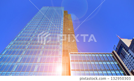 Exterior of modern high-rise buildings in a business district. Tall office buildings. Glass-fronted skyscrapers. Modern business district. 132950303
