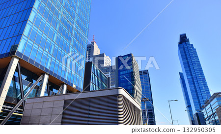 Exterior of modern high-rise buildings in a business district. Tall office buildings. Glass-fronted skyscrapers. Modern business district. 132950305