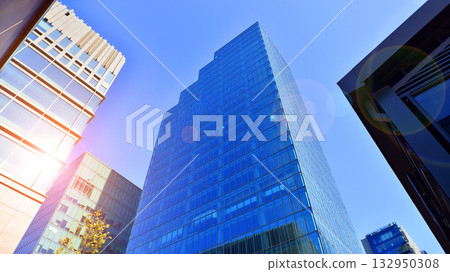 Exterior of modern high-rise buildings in a business district. Tall office buildings. Glass-fronted skyscrapers. Modern business district. Exterior of modern high-rise buildings in a business district. Tall office buildings. Glass-fronted skyscrapers. Modern business district. 132950308