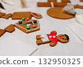 Children decorating gingerbread house with icing and candy, Christmas fun activity 132950325