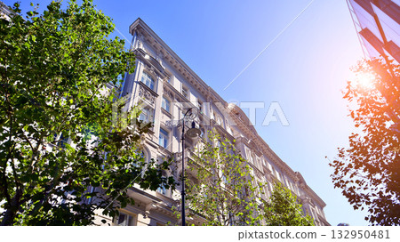 Modern luxury office building.The structure features a glass and concrete walls, showcasing contemporary architecture. The green surroundings of office buildings. Trees and shrubs in the city. Modern luxury office building.The structure features a glass and concrete walls, showcasing contemporary architecture. The green surroundings of office buildings. Trees and shrubs in the city. 132950481