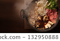 Luxurious authentic Wagyu beef sukiyaki in a steaming pot with a wood grain background 132950888