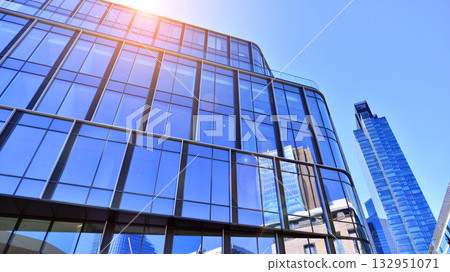 Exterior of modern high-rise buildings in a business district. Tall office buildings. Glass-fronted skyscrapers. Modern business district. 132951071