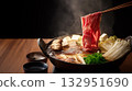 Red against a black background: the drama of premium Wagyu beef being lifted with chopsticks 132951690