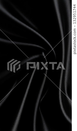 Luxurious black satin fabric folds with elegant light and shadow creating a sophisticated, modern, and versatile background for design projects. 132951744