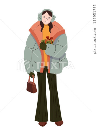 Smiling woman in winter outfit holding holiday gift box and handbag wearing earmuffs puffer jacket gloves and flared pants in cozy seasonal style 132951785