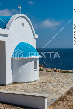 Traditional white chapel with a blue roof on the seaside. Agioi Anargyroi, Cyprus 132952115